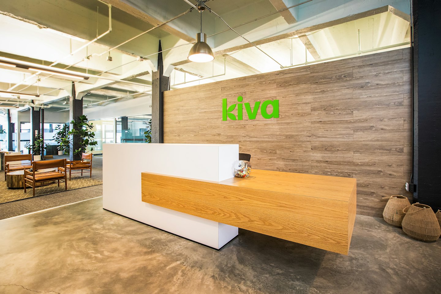 Sleek reception desk in a modern office waiting area.